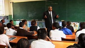 A teacher in a classroom with learners