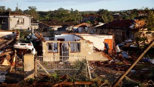 People sift through the remains of their homes damaged by a tornado in Tongaat, South Africa, June 4, 2024.