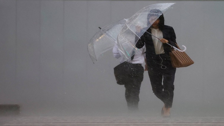 [File Image] Pedestrians holding umbrellas during a downpour in June 2023.