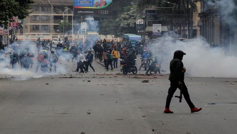 A police officer walks after using tear gas to disperse protesters during a demonstration over police killings of people protesting against Kenya's proposed finance bill 2024/2025, in Nairobi, Kenya, June 27, 2024.